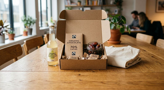 A fair trade corporate gift box with chocolate, dates and a cotton bag on a meeting room table